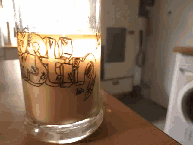a glass with graffiti on it that says home sweet