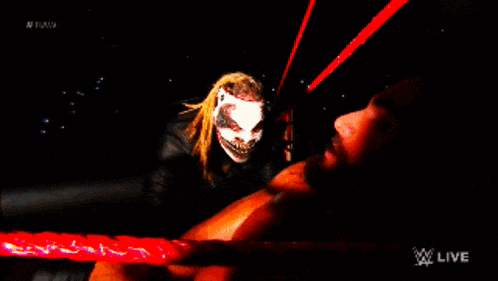 a man is laying on the ground with a monster standing behind him and the words w live on the bottom