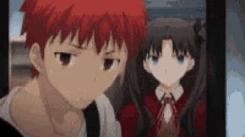 a boy and a girl are standing next to each other in front of a tv .