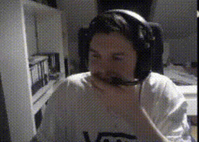 a person wearing headphones and a shirt that says vans