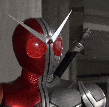 a close up of a masked rider with a sword in his right hand