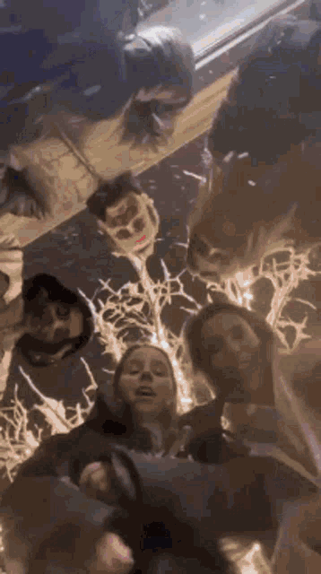 a group of people are standing in a circle with their heads in the middle .
