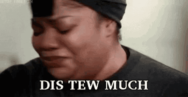 a woman is crying with the words `` dis tew much '' written on her face .