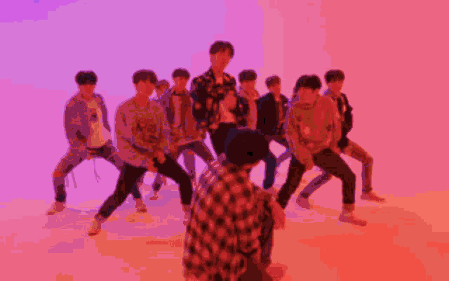 a group of young men are dancing and one of them has the letter a on his shirt