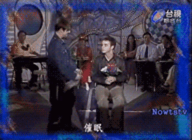 a man in a wheelchair is being helped up by another man
