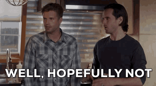 two men are standing next to each other in a kitchen and one of them is saying well , hopefully not .