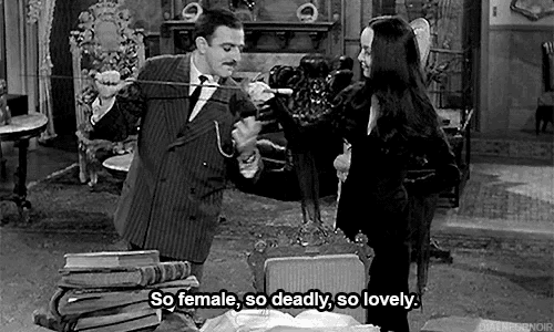 a man and a woman are standing next to each other in a room .