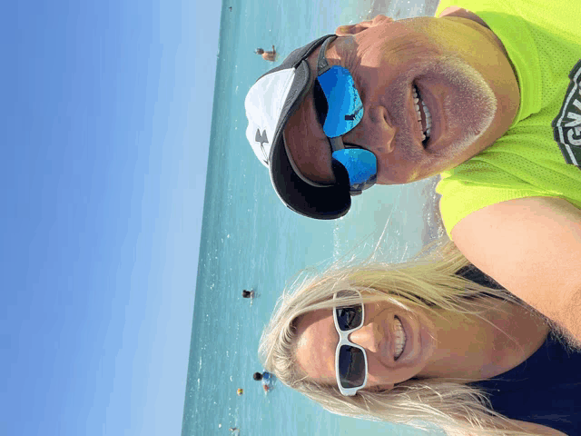 a man and a woman wearing sunglasses and a yellow shirt with the word vans on it