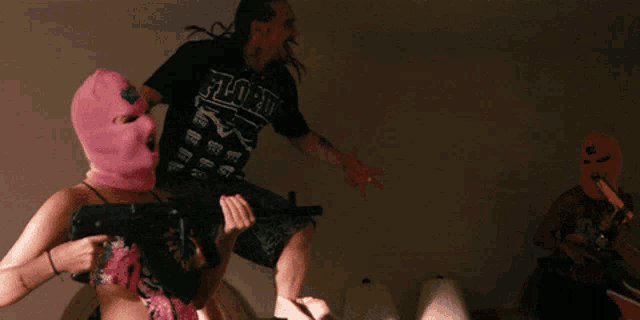a man wearing a shirt that says ' florida ' on it is holding a gun
