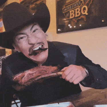 a man in a cowboy hat is eating a piece of meat in front of a sign that says united states of bbq