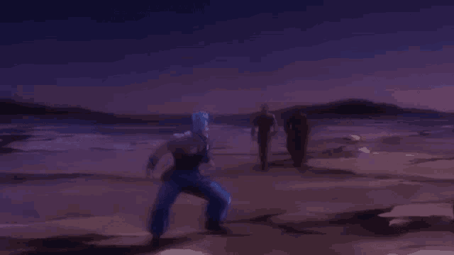 a man in blue pants is jumping in the air in a desert