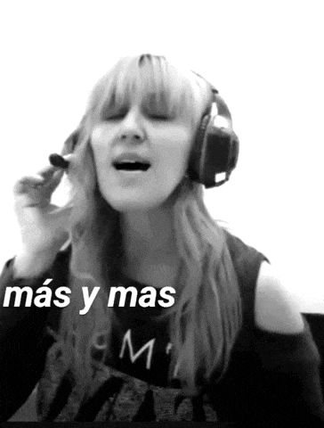 a woman wearing headphones is singing a song in spanish