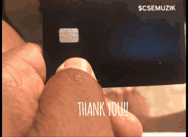 a person is holding a credit card that says scsemuzik on it
