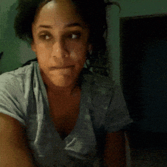 a blurry picture of a woman 's face with her hand on her chin
