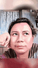 a woman is making a funny face with her hand on her chin