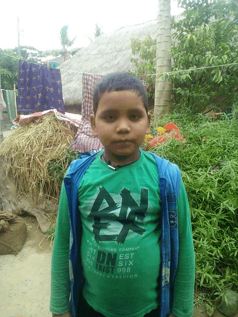 a boy wearing a green shirt that says an