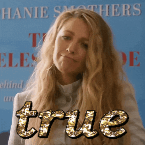 a woman stands in front of a sign that says " true "