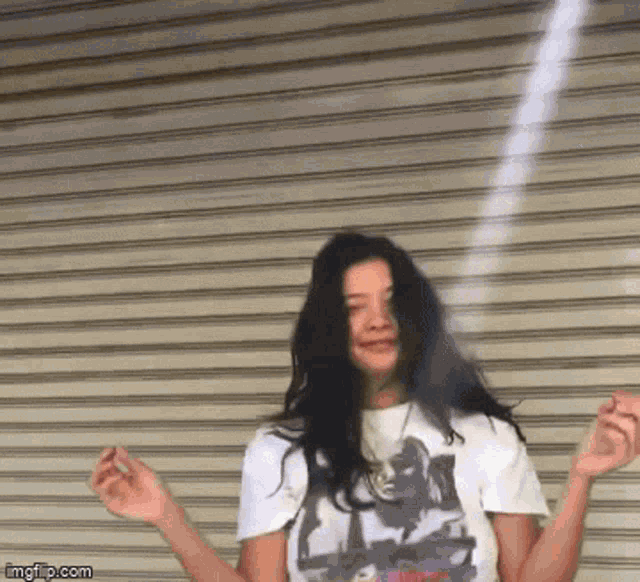 a woman in a t-shirt with a picture of a woman on it is dancing