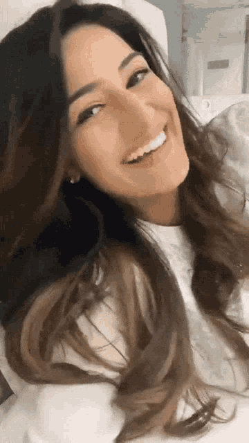 a close up of a woman 's face with a smile on her face