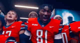 a football player with the number 81 on his jersey is surrounded by his teammates