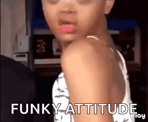 a little girl is making a funny face and the words funky attitude are visible behind her .
