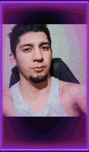 a man with a beard is taking a selfie in front of a purple background