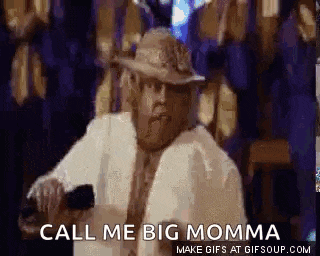 a man wearing a hat and a white coat is holding a cell phone and says `` call me big momma '' .