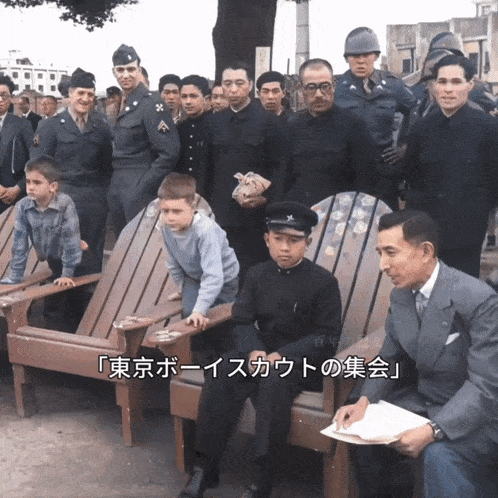 a group of people sitting in wooden chairs with a caption that says " tokyo boys scout "
