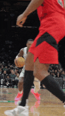 a basketball player wearing a number 9 jersey dribbles a basketball