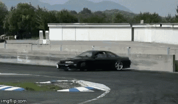 a black car is drifting on a track with a imgflip.com watermark