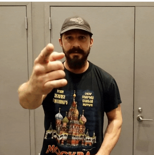 a man wearing a black t-shirt that says ' moscow ' on it