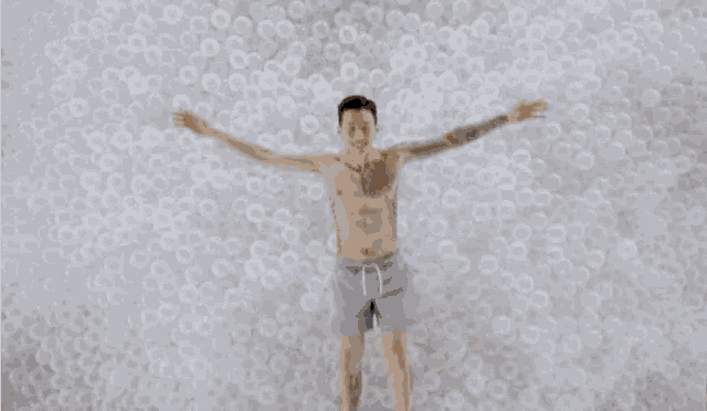 a person is laying in a pile of bubbles .