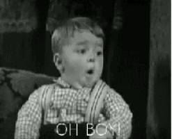 a black and white photo of a young boy saying oh boy .