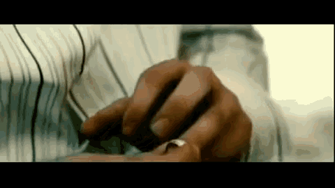 a close up of a man 's hand with a wedding ring on it