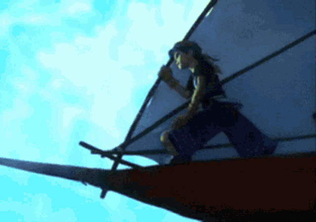 a person is standing on a boat with a sail