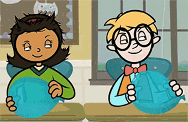 a boy and a girl are sitting at desks in a classroom holding balls