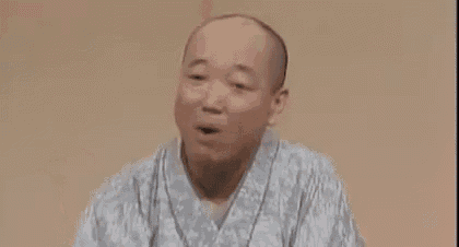 a bald man in a kimono is making a funny face while holding a cigarette .
