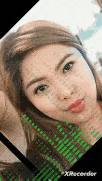 a woman 's face is displayed on a screen with xrecorder at the bottom