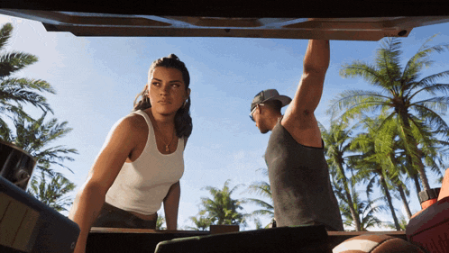 a man and a woman standing in the back of a car