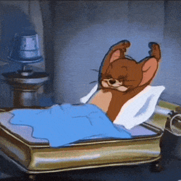 a cartoon jerry is laying on a bed with a blue blanket