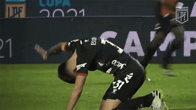 a soccer player is kneeling down in front of the word cam