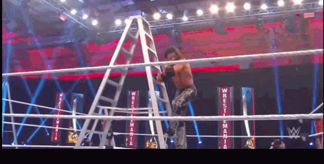 a wrestler climbs a ladder into a wrestling ring