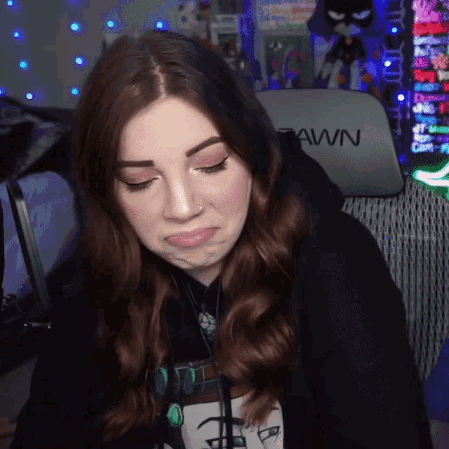 a woman is sitting in front of a chair that says pawn