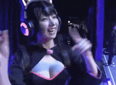 a woman wearing headphones is smiling and waving her hands in the air