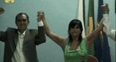 a man and a woman are holding hands with their arms in the air .