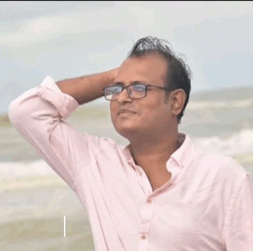 a man wearing glasses and a pink shirt with the words super singing on the bottom right