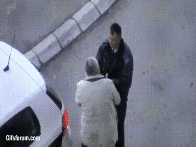 two men are standing next to each other in front of a white car with gifsforum.com written on the bottom right