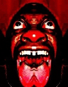 a close up of a man 's face with his mouth open and tongue sticking out .