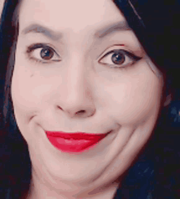 a close up of a woman 's face with red lipstick making a funny face