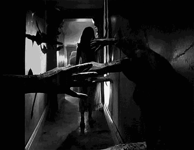 a black and white photo of a woman being attacked by a demon .